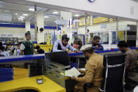 Afghans wait to receive their posts in the main post office in the city of Kabul, Afghanistan, Wednesday, July 3, 2024. In parts of Afghanistan where there are no street names or house numbers, utility companies and their customers have adopted a creative approach for connecting. They use mosques as drop points for bills and cash, a "pay and pray" system. (AP Photo/Siddiqullah Alizai)