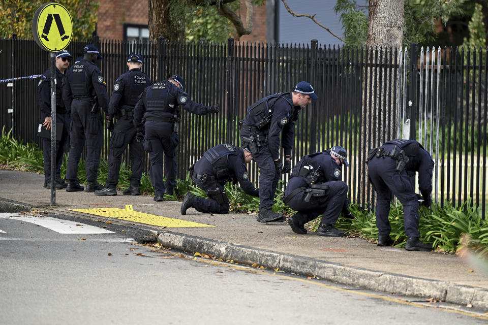 New South Wales state Police conduct search at the scene of an alleged stabbing at Sydney University, in Sydney, Tuesday, July 2, 2024. A 14-year-old boy dressed in military clothing was arrested after stabbing a 22-year-old student in the neck at Sydney University, police alleged. (Dan Himbrechts/AAP Image via AP)