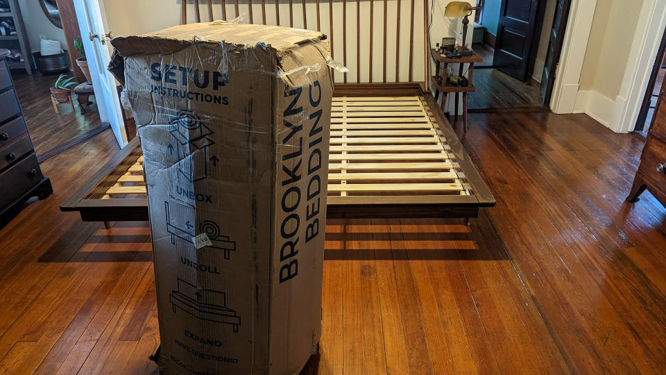 Brooklyn Bedding Signature Hybrid mattress in a box next to a bed frame