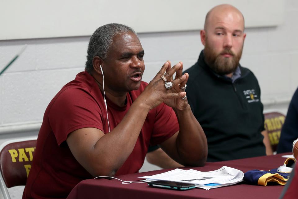 Coach Willie Washington speaks to students and parents during a meet-and-greet May 24 for Patriot Prep's inaugural football season this fall. The program will start with a middle school team. Also pictured is assistant coach Jordan Flory.