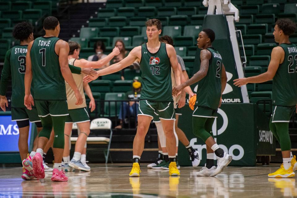 Colorado State's Patrick Cartier high-fives his teammates as he heads to the free-throw line shortly after being fouled during the CSU men's basketball Homecoming scrimmage in Moby Arena on Saturday, Oct. 15, 2022, in Fort Collins, Colo.