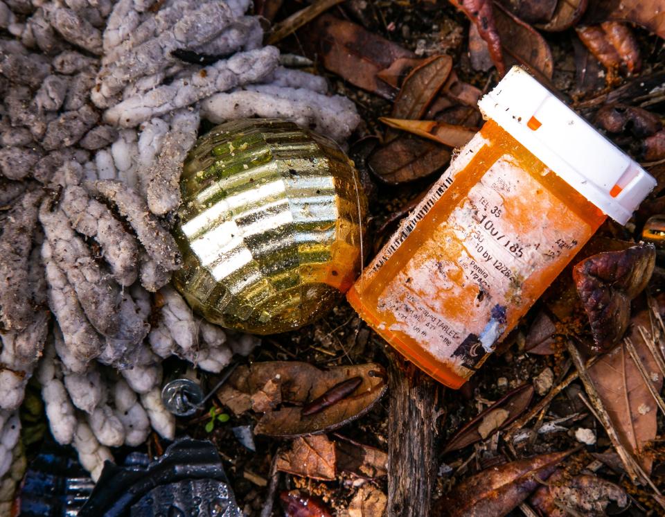 A medicine bottle was illegally dumped with serval bags of household garbage and other items in an empty lot near the corner of SE 102nd Terrace and SE 125th Lane on 125th Lane in Belleview, photographed May 13.