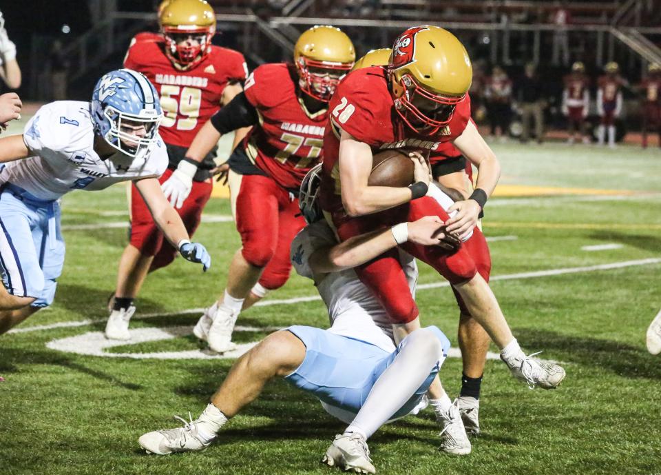 Mount Olive's Adam DeCristofaro can't break away from Wayne Valley's defense during the first half of a football game at Mount Olive High School on October 27, 2023.
