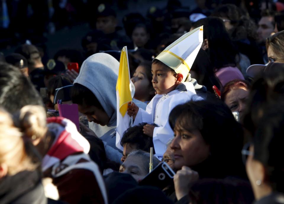 A boy wears a pope costume while waiting along with others for Pope Francis to leave the nunciature in Mexico City, February 17, 2016. (REUTERS/Carlos Jasso)