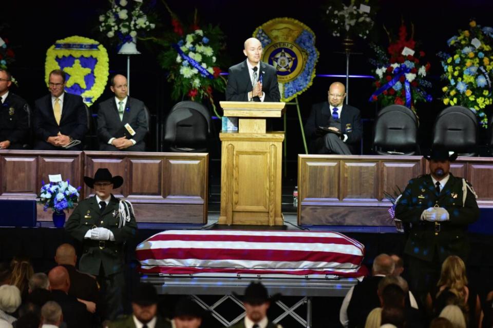  Utah Gov. Spencer Cox speaks during the funeral of Santaquin Police Sgt. Bill Hooser at the Utah Valley University’s UCCO Event Center on Monday, May 13, 2024. (Kyle Dunphey/Utah News Dispatch)