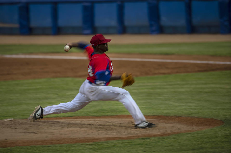 Cuba's pitcher Yoanni Yera Montalvo throws the ball during a training session at the Estadio Latinoamericano in Havana, Cuba, Tuesday, May 18, 2021. A little over a week after the start of the Las Americas Baseball Pre-Olympic in Florida, the Cuban team does not have visas to travel to the United States. (AP Photo/Ramon Espinosa)