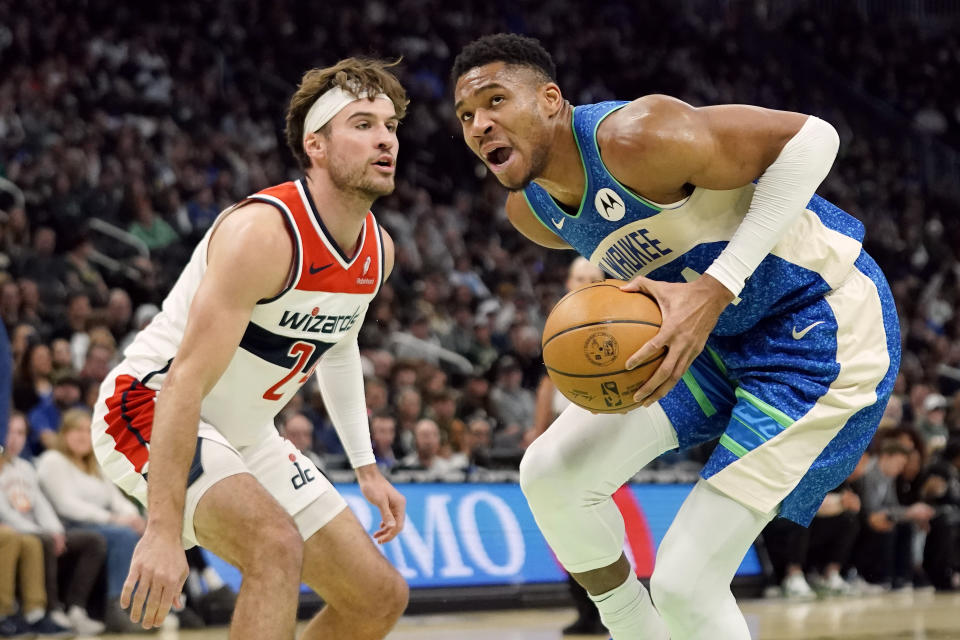 Milwaukee Bucks' Giannis Antetokounmpo, right, looks to shoot past Washington Wizards' Corey Kispert during the first half of an NBA basketball game Friday, Nov. 24, 2023, in Milwaukee. (AP Photo/Aaron Gash)