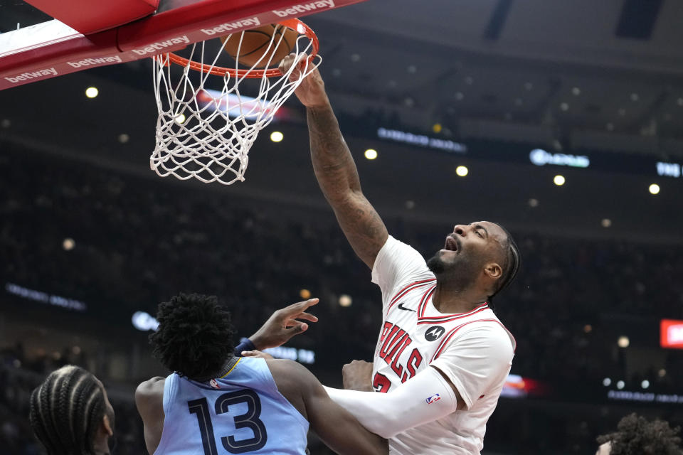 Chicago Bulls' Andre Drummond, right, misses a dunk over Memphis Grizzlies' Jaren Jackson Jr. during the first half of an NBA basketball game Saturday, Jan. 20, 2024, in Chicago. (AP Photo/Charles Rex Arbogast)