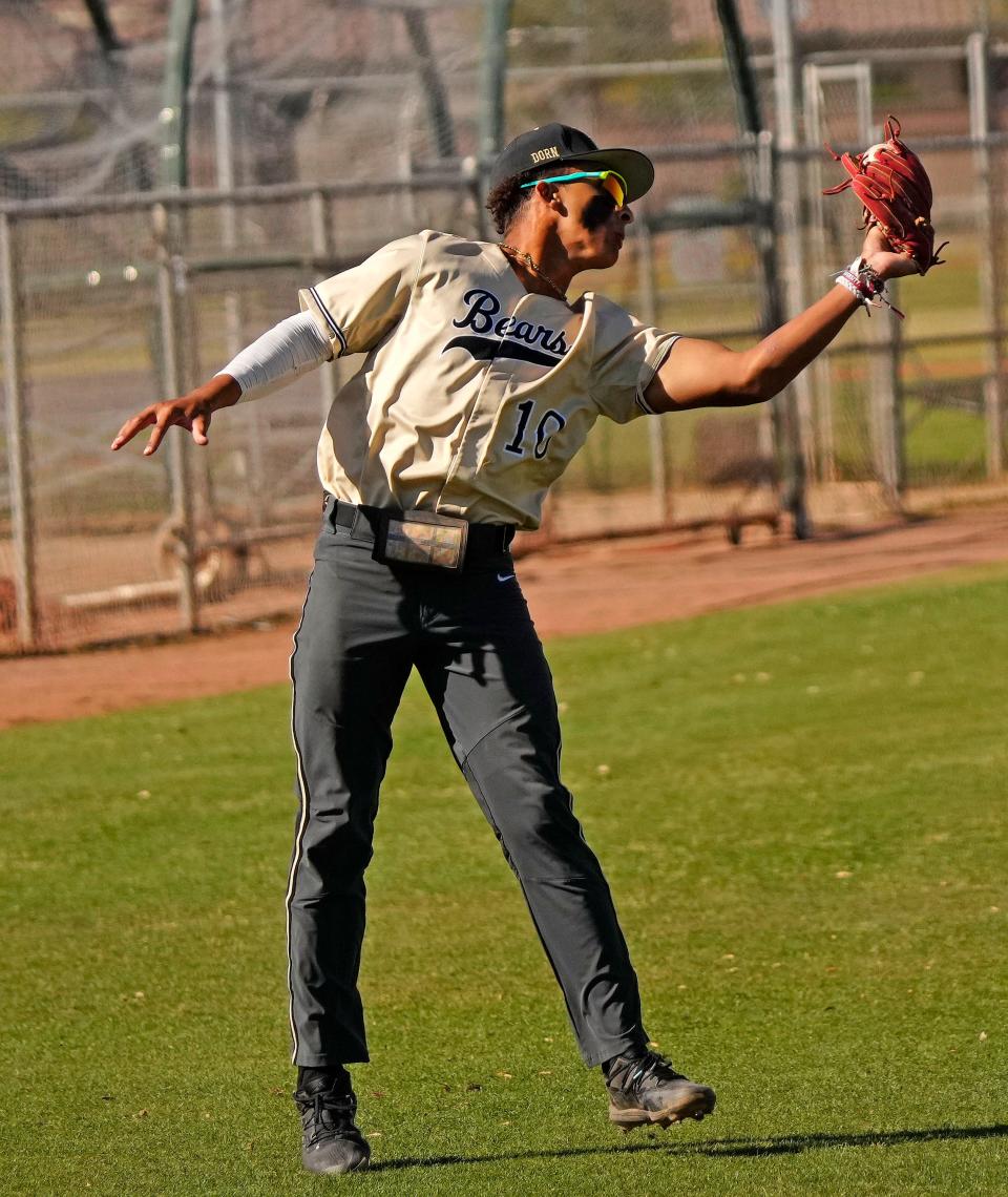 Basha infielder Gavin Smith (10) catches a pop-out against Hamilton during a game at Hamilton High School in Chandler on April 4, 2023.