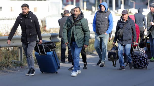 PHOTO: A group of Russians walk after crossing the border at Verkhny Lars between Georgia and Russia in Georgia, on Sept. 27, 2022. (Zurab Tsertsvadze/AP)