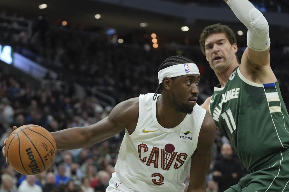 Cleveland Cavaliers' Caris LeVert drives by Milwaukee Bucks' Brook Lopez during the first half of an NBA basketball game Wednesday, Jan. 24, 2024, in Milwaukee. (AP Photo/Morry Gash)