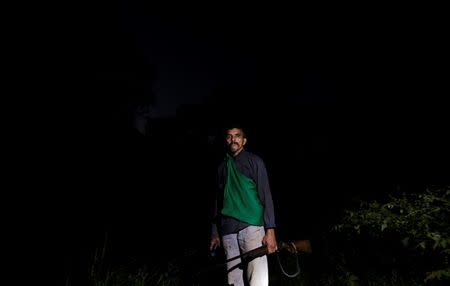 Domingos da Conceicao, 54, who has worked as a rubber extractor since his childhood, poses for a photograph in the woods around his home, as he leaves to hunt in Chico Mendes Extraction Reserve in Xapuri, Acre state, Brazil, June 23, 2016. REUTERS/Ricardo Moraes