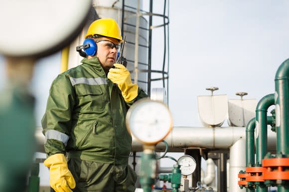 A man standing in front of pipeline infrastructre