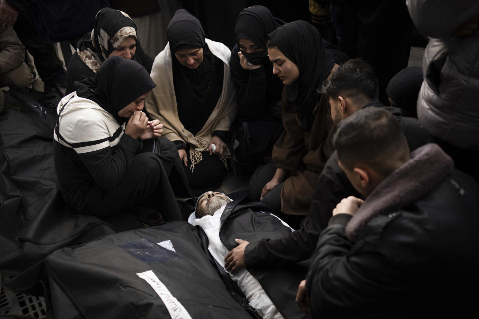 Palestinians mourn relatives killed in the Israeli bombardment of the Gaza Strip at a hospital morgue in Rafah, Monday, March 4, 2024. (AP Photo/Fatima Shbair)