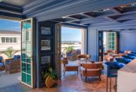 <p><strong>Give us an overview of the space.</strong> There’s a formal/casual symbiosis going on at this ninth-floor rooftop Champagne and cocktail bar. <a href="https://www.cntraveler.com/hotels/charleston/hotel-bennett?mbid=synd_yahoo_rss" rel="nofollow noopener" target="_blank" data-ylk="slk:The Bennett Hotel;elm:context_link;itc:0;sec:content-canvas" class="link ">The Bennett Hotel</a> is one of downtown Charleston’s more refined spots, and the main bar interior reflects this. A regal dark purple palette dominates the space, with panelling that lands somewhere between Regency-era finery and a colorful spaceship. Patio doors lead to the far less buttoned-up terrace, and a deep blue pool surrounded by cabanas and seating. Views of Marion Square, King Street and St Matthews Lutheran Church stretching out below.</p> <p><strong>How’s the crowd?</strong> As well as hotel guests topping up their cocktails as they lounge by the pool, there’s a buzzy, post-work crowd of locals who are in-the-know enough to head straight here rather than the lobby bar. The somewhat-premium prices mean that it’s a natural choice for special occasions, with birthday and anniversary drinks driving the popping of Champagne corks. It’s mostly a well-dressed clientele, with swimming gear becoming less and less prevalent as the evening progresses.</p> <p><strong>How are the drinks?</strong> The house cocktails skew light and citrus-influenced, with infused vodkas and gins leading the way, perfect for hot and humid Charleston summers. Playful names—one of their signature drinks is called Don’t Kale My Vibes—abound, and esoteric ingredients such as strawberry jam and dragon fruit make appearances. A compact but serviceable wine list and a host of locally-brewed beers back up the mixed drinks list.</p> <p><strong>What do they have for food?</strong> Complementing the cocktail list, the kitchen has a choice of light bites. A mezze platter, charcuterie and a poached pear salad are typically fresh options, and there’s a couple of sandwich and burger options for bigger appetites. Their shrimp salad croissant combines the best of both worlds, and Belgian frites elevate their fry game nicely.</p> <p><strong>Did the staff do you right?</strong> The bar staff are relaxed and can confidently lead the curious through their cocktails, even suggesting bespoke creations if it’s not too busy. Originals with whimsical touches such as edible gold glitter stars and activated charcoal delight the more adventurous imbibers. A friendly, casual professionalism is the order of the day, and it creates a welcoming, unpretentious ambience.</p> <p><strong>Wrap it up: what are we coming here for?</strong> This bar feels quite idyllic as you order your second cocktail, the sun going down and the bells of St. Matthews ringing. You definitely get a downtown oasis vibe, and the luxe status of the hotel extends to the design of the bar. It’s a good option when you want to up the stakes a little for a date or a celebration, and the choice of indoor and outdoor spaces along with the views complete a great night out.</p>