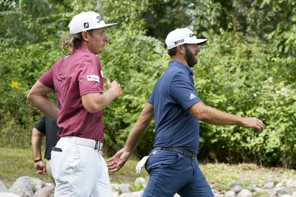 Cameron Smith, left, and Dustin Johnson head toward the fourth fairway during the final round of the LIV Golf Invitational-Chicago tournament Sunday, Sept. 18, 2022, in Sugar Hill, Ill. (AP Photo/Charles Rex Arbogast)