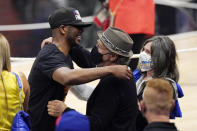 Phoenix Suns guard Chris Paul, left, hugs actor Billy Crystal, center, as Crystal's wife Janice stands by after the Suns won Game 6 of the NBA basketball Western Conference Finals against the Los Angeles Clippers Wednesday, June 30, 2021, in Los Angeles. The Suns won the game 130-103 to take the series 4-2. (AP Photo/Mark J. Terrill)