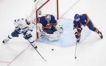 Tampa Bay Lightning left wing Patrick Maroon (14) is stopped by New York Islanders goaltender Semyon Varlamov (40) as Islanders defenseman Ryan Pulock (6) reaches for the puck during the third period of Game 6 of the NHL hockey Eastern Conference final, Thursday, Sept. 17, 2020, in Edmonton, Alberta. (Jason Franson/The Canadian Press via AP)