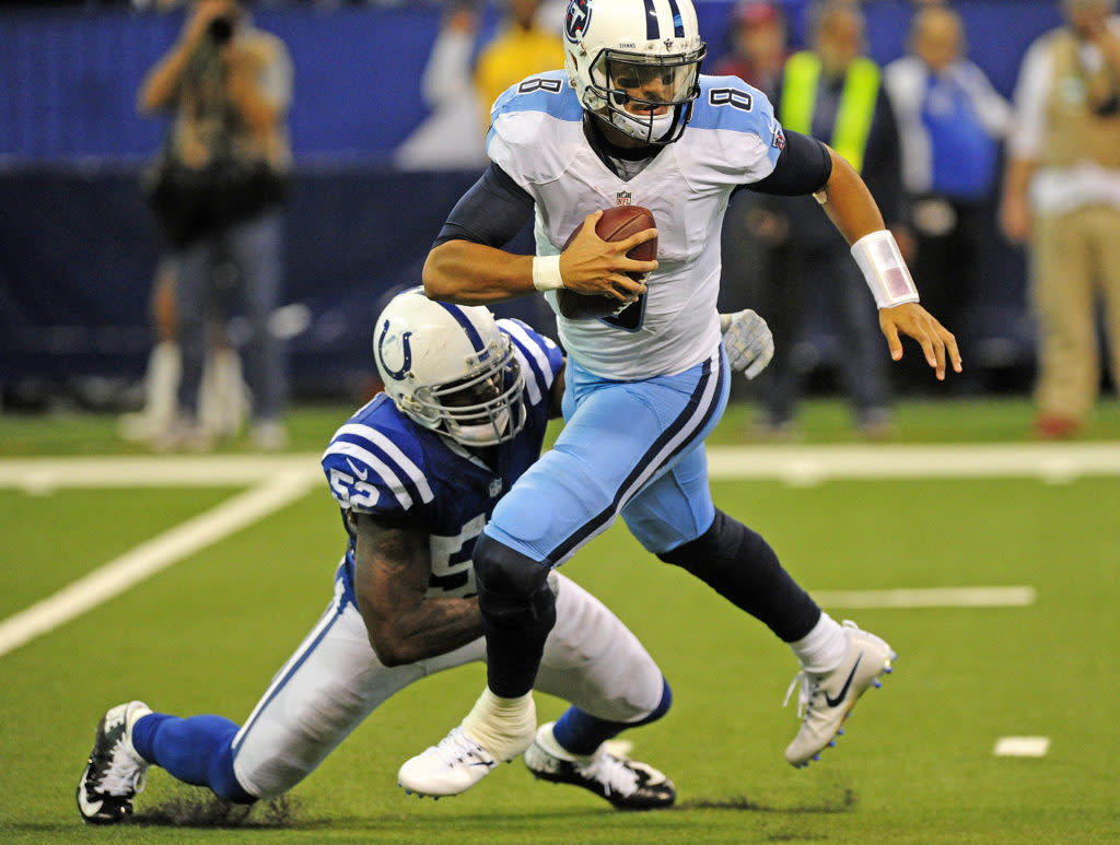 Caption: Nov 20, 2016; Indianapolis, IN, USA; Tennessee Titans quarterback Marcus Mariota (4) tries to elude Indianapolis Colts linebacker D'Qwell Jackson (52) at Lucas Oil Stadium. Mandatory Credit: Thomas J. Russo-USA TODAY Sports