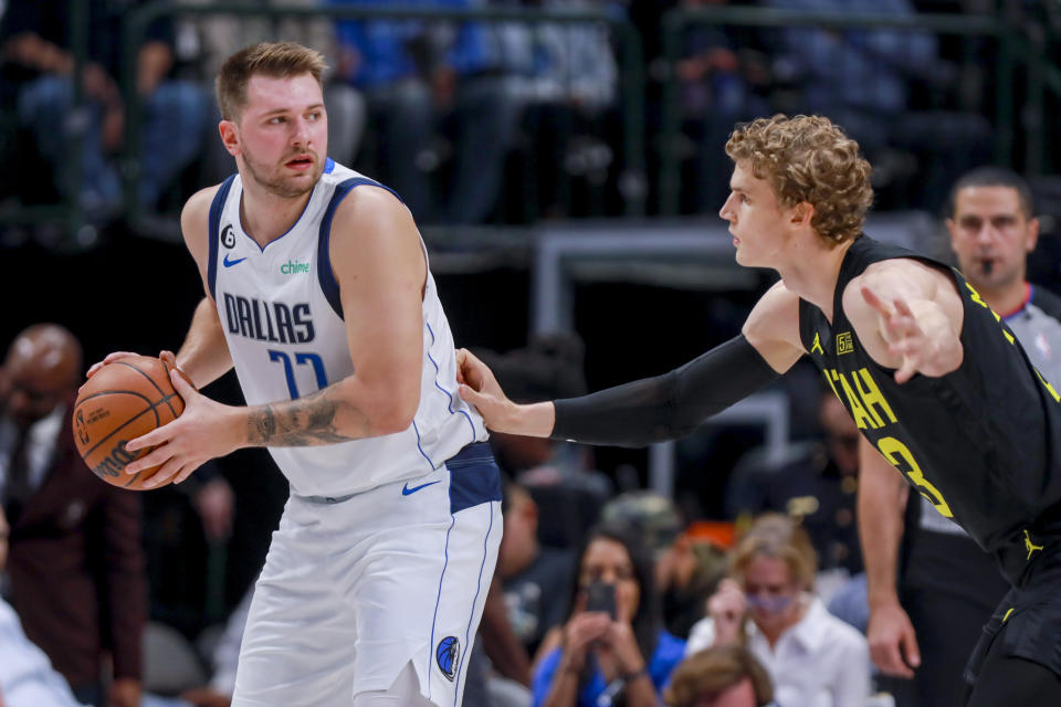 Dallas Mavericks point guard Luka Doncic. (77) is defended by Utah Jazz forward Lauri Markkanen during the first half of an NBA basketball game Wednesday, Nov. 2, 2022, in Dallas. (AP Photo/Gareth Patterson)