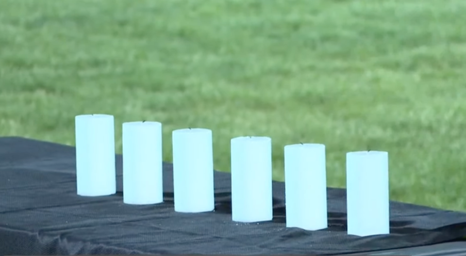 Six candles were lit at the vigil, one for each victim (WKNYC Channel 3)