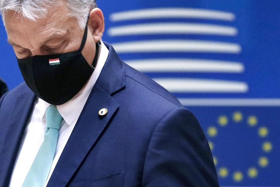 FILE- In this Saturday, July 18, 2020, file photo, Hungary's Prime Minister Viktor Orban wears a protective face mask as he arrives for a round table meeting at an EU summit in Brussels. Hungary's prime minister says that his country won a “very important battle” at the European Union summit this week, where national leaders of the 27-member bloc decided an seven-year budget and economic recovery package to counter the effects of the coronavirus pandemic. (Francois Lenoir, Pool Photo via AP. File)