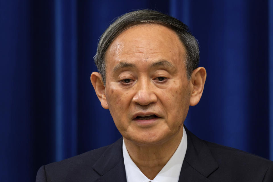 Japan's Prime Minister Yoshihide Suga delivers a speech during a press conference on the COVID-19 situation in Japan at the prime minister's office in Tokyo, Friday, Dec. 25, 2020. Suga said on Friday he will seek a legislation to allow the government to impose legally-binding business restriction orders in return for compensation and punish violators as Japan struggles to slow the ongoing upsurge of the coronavirus cases ahead of the holiday season while people are becoming less cooperative. (Nicolas Datiche/Pool Photo via AP)