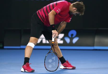 Tennis - Australian Open - Melbourne Park, Melbourne, Australia - 26/1/17 Switzerland's Stan Wawrinka reacts after hitting a shot during his Men's singles semi-final match against Roger Federer. REUTERS/Thomas Peter