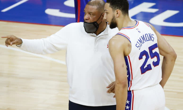 Doc Rivers speaks with Ben Simmons during a timeout.