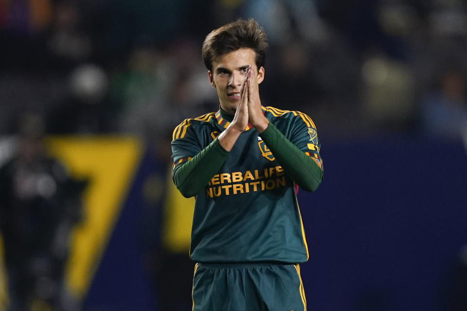 LA Galaxy midfielder Riqui Puig gestures to the crowd during the second half of the team's MLS soccer match against Minnesota United, Wednesday, Sept. 20, 2023, in Carson, Calif. (AP Photo/Ryan Sun)