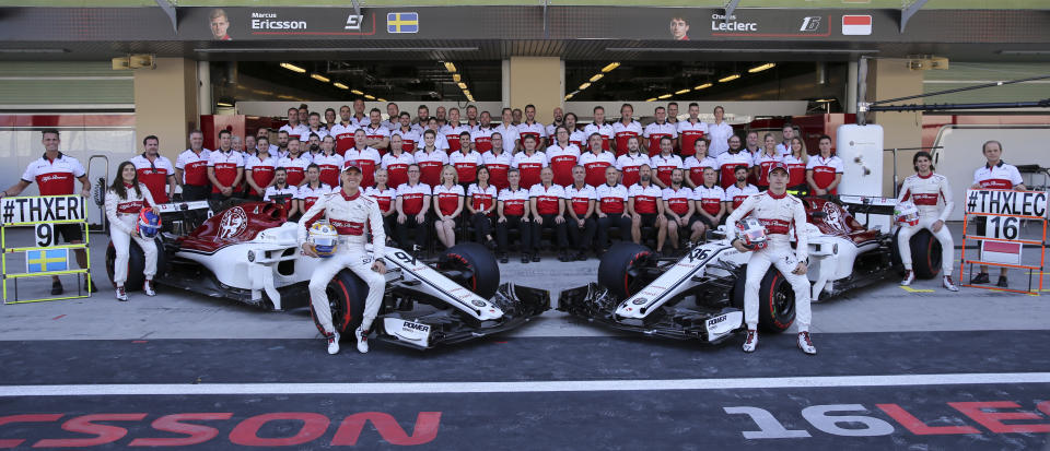 Sauber drivers Marcus Ericsson of Sweden, left, and Charles Leclerc of Monaco pose with the team before the first free practice at the Yas Marina racetrack in Abu Dhabi, United Arab Emirates, Friday Nov. 23, 2018. The Emirates Formula One Grand Prix will take place on Sunday. (AP Photo/Kamran Jebreili)