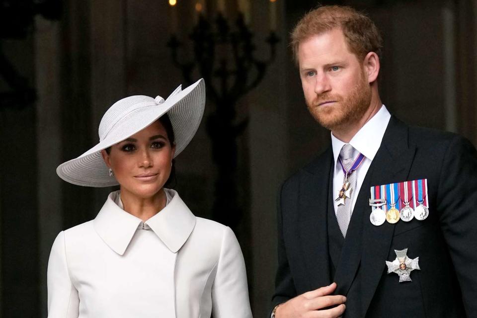 <p>Matt Dunham - WPA Pool/Getty</p> Meghan Markle and Prince Harry exit the National Service of Thanksgiving during Queen Elizabeth