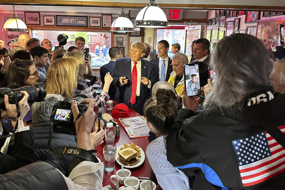 Former President Donald Trump greets supporters at the Red Arrow Diner after his rally, Thursday, April 27, 2023, in Manchester, N.H. (AP Photo/David R. Martin)