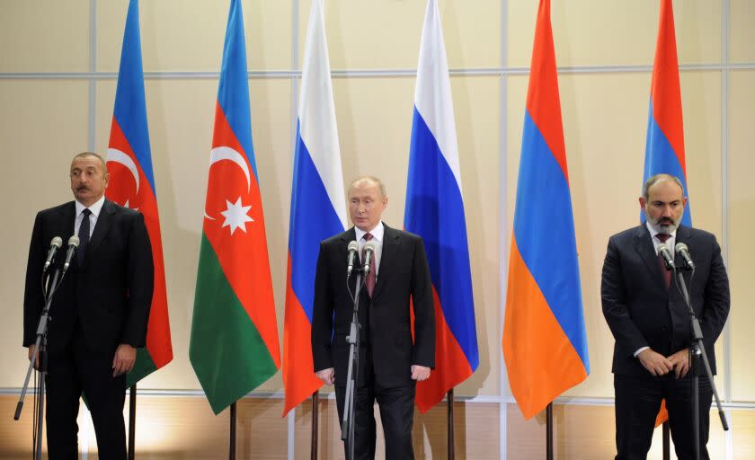 FILE - Russian President Vladimir Putin, center, Azerbaijan's President Ilham Aliyev, left, and Armenia's Prime Minister Nikol Pashinyan attention a news conference during their meeting in the Bocharov Ruchei residence in the Black Sea resort Sochi, Russia, on Nov. 26, 2021. A senior U.N. official urged the international community Tuesday, Dec. 20, 2022, to prevent Armenia and Azerbaijan from resuming their conflict over the disputed Nagorno-Karabakh region as the two countries accused each other of violating a Russian-brokered peace agreement.(Mikhail Klimentyev, Sputnik, Kremlin Pool Photo via AP, File)