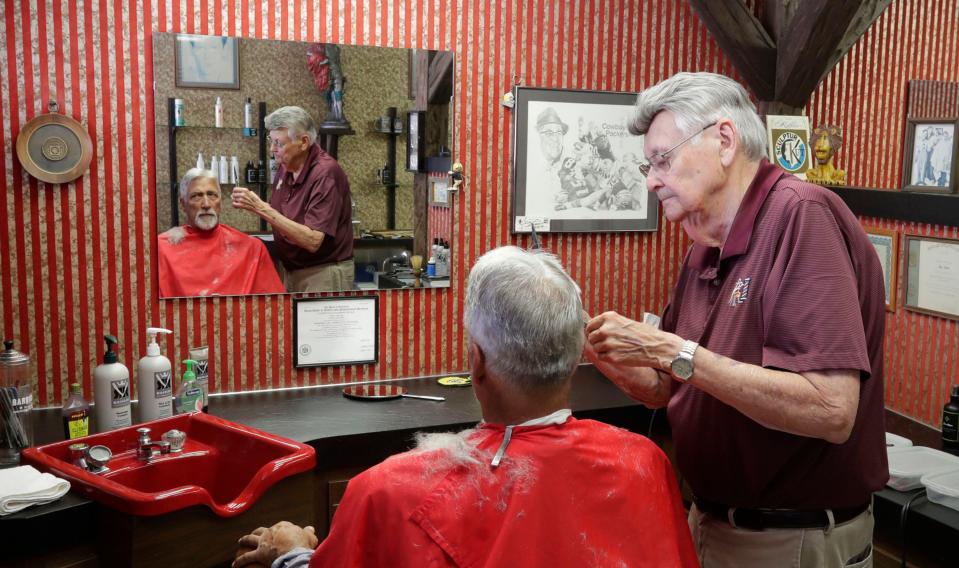 Antonie’s Barber Shop’s John Antonie, left, cuts the hair of Phil Rodriguez, of Manitowoc, during a haircut Aug. 22, 2023, in Two Rivers, Wis. Owner John Antonie is retiring after over 60 years as a barber.