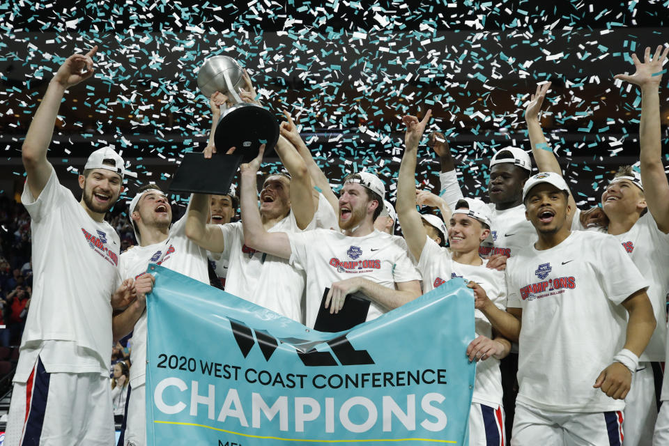 FILE - Gonzaga players celebrate after defeating Saint Mary's in an NCAA college basketball game in the final of the West Coast Conference men's tournament in Las Vegas, in this Tuesday, March 10, 2020, file photo. Gonzaga will begin the college basketball season No. 1 for the first time after coach Mark Few's bunch earned 28 first-place votes in the preseason AP Top 25 poll released Monday, Nov. 9, 2020.(AP Photo/John Locher, File)