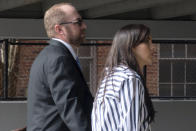 Patrick Parker Walsh, left, heads to his car with his wife in Gainesville, Fla. on Tuesday, Jan. 31, 2023, after he was sentenced to five and a half years in federal prison for stealing nearly $8 million in federal COVID-19 relief funds. He surrendered himself for imprisonment at a later date. (Augustus Hoff/WUFT News via AP)