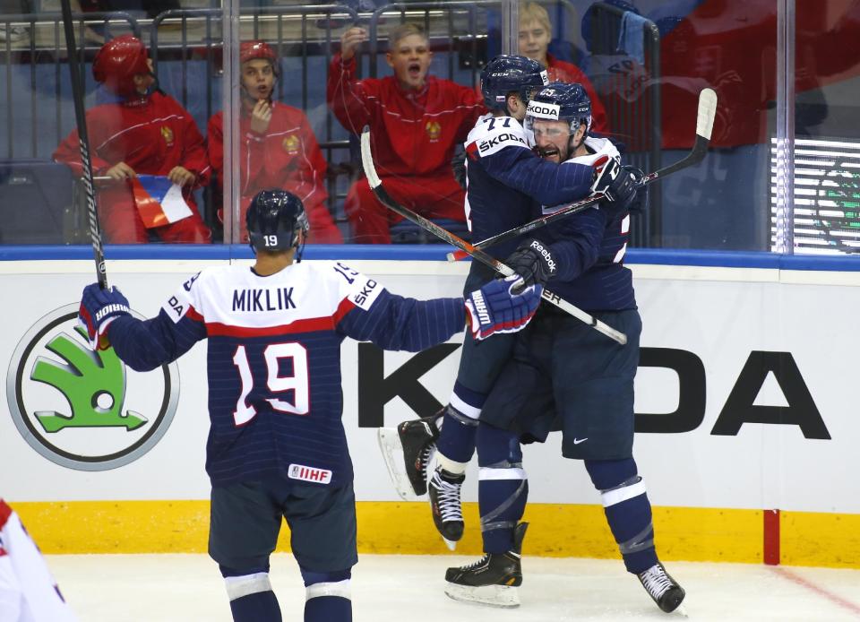 Slovakia's players celebrate after Marek Viedensky, right, scored against Czech Republic during the Group A preliminary round match at the Ice Hockey World Championship in Minsk, Belarus, Friday, May 9, 2014. (AP Photo/Sergei Grits)