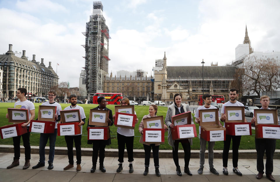 Activists from the People's Vote campaign show 'Deal or No Deal' boxes in London, Monday, Jan. 14, 2019. Britain's Prime Minister Theresa May is struggling to win support for her Brexit deal in Parliament. Lawmakers are due to vote on the agreement Tuesday, and all signs suggest they will reject it, adding uncertainty to Brexit less than three months before Britain is due to leave the EU on March 29. (AP Photo/Frank Augstein)