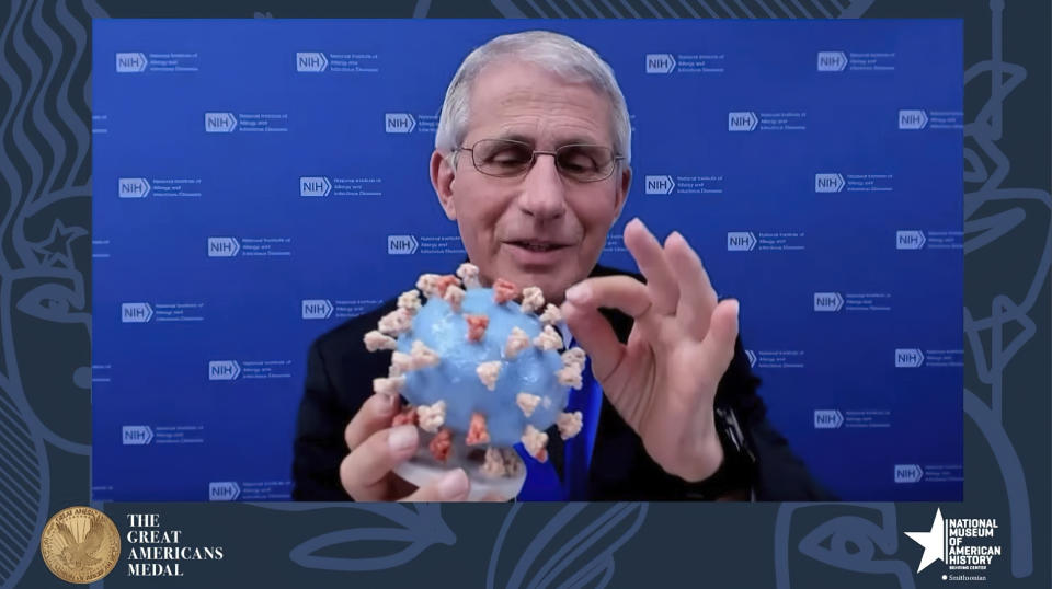 FILE - This image from video provided by Smithsonian's National Museum of American History shows Dr. Anthony Fauci, director of the National Institute of Allergy and Infectious Diseases and chief medical adviser to the president, holding his personal 3D model of the COVID-19 virus he is donating to the Smithsonian's National Museum of American History on March 2, 2020. Fauci steps down from a five-decade career in public service at the end of the month, one shaped by the HIV pandemic early on and the COVID-19 pandemic at the end. (Smithsonian's National Museum of American History via AP, File)