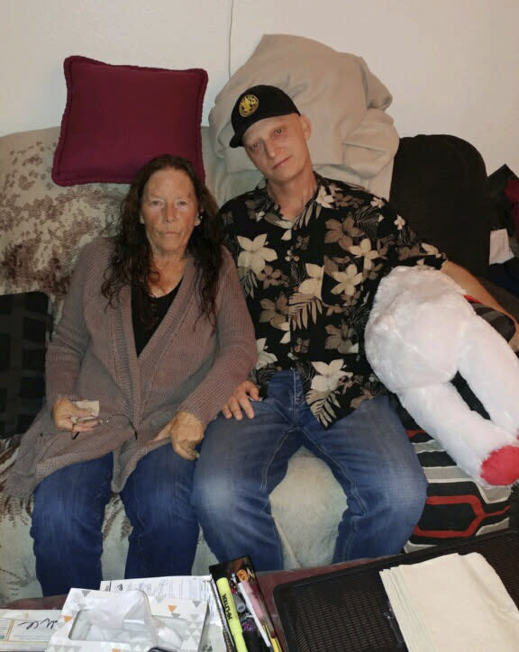 FILE - In this 2018, file photograph released by lawyer Mark Zaid, Michael R. White, right, is seen with his mother, Joanne White, left. Michael White, a Navy veteran detained in Iran for nearly two years, has been released and is on his way home as part of an unusual agreement to free an Iranian-American physician who was prosecuted in the United States, U.S. officials said Thursday, June 4, 2020. (White family via AP)