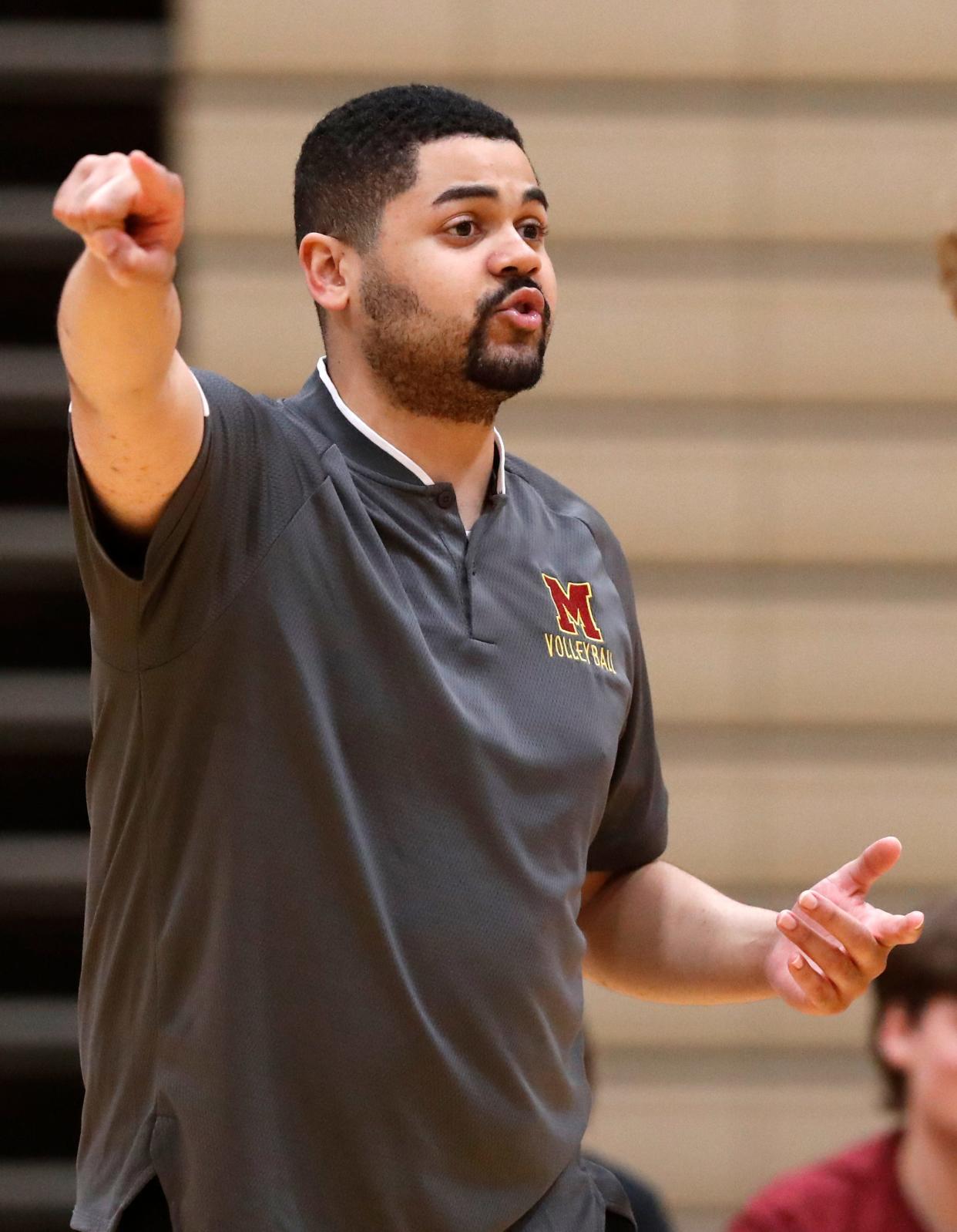 Former McCutcheon Mavericks head coach now Wabash College men's volleyball coach Ashaun Baker yells down court during the IHSAA boys volleyball sectional championship against the Harrison Raiders, Saturday, May 13, 2023, at Harrison High School in West Lafayette, Ind.