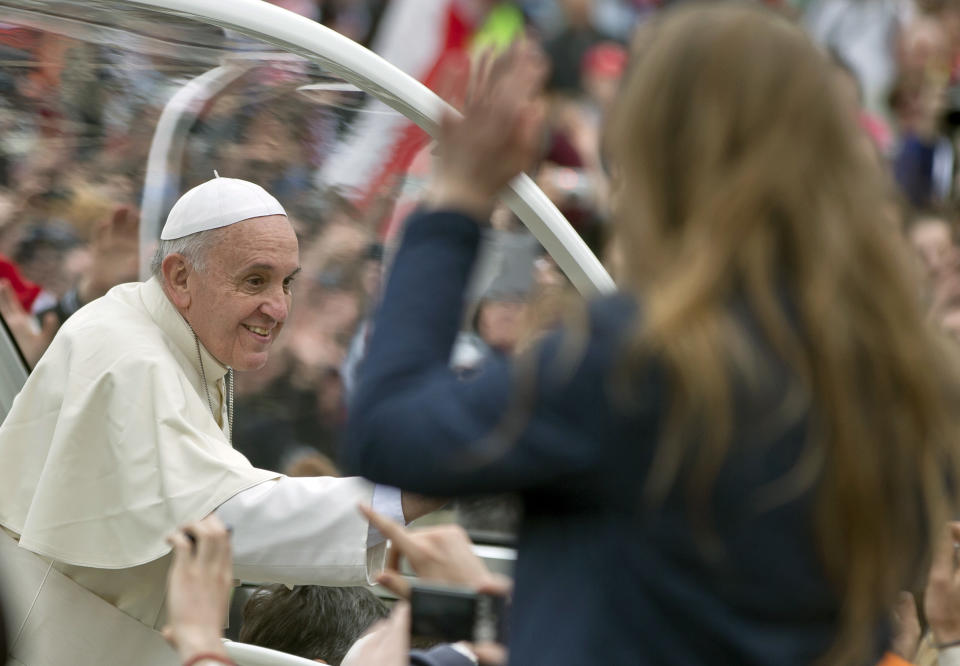 Pope Francis is driven through the crowd in St. Peter's Square at the Vatican, Sunday, April 27, 2014. Pope Francis has declared his two predecessors John XXIII and John Paul II saints in an unprecedented canonization ceremony made even more historic by the presence of retired Pope Benedict XVI. (AP Photo/Vadim Ghirda)