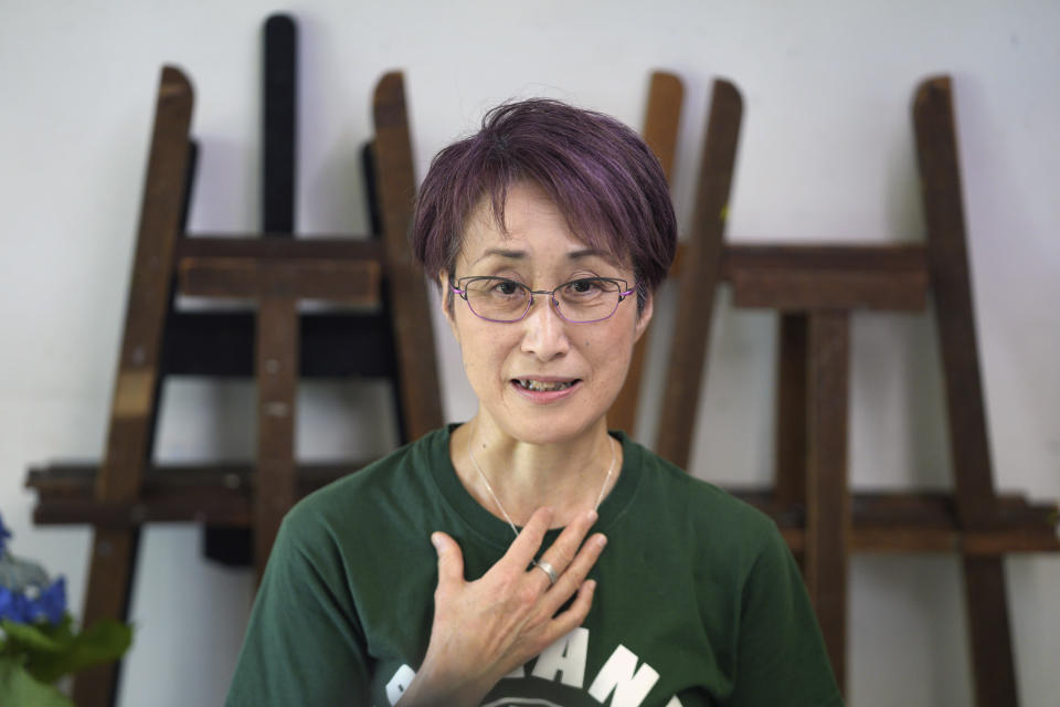 Japanese artist Miwako Sakauchi speaks about her art work for an art exhibition "Declaration of the end of Olympic games" in Chiba near Tokyo Thursday, June 10, 2021. “What I can do instead of going to (anti-Olympics) protests is to use my expertise in art,” said Sakauchi of her motivation to produce the paintings. She has never participated in street protests or incorporated political issues into her abstract paintings in the past, but the Tokyo Olympics have been a tipping point. (AP Photo/Eugene Hoshiko)