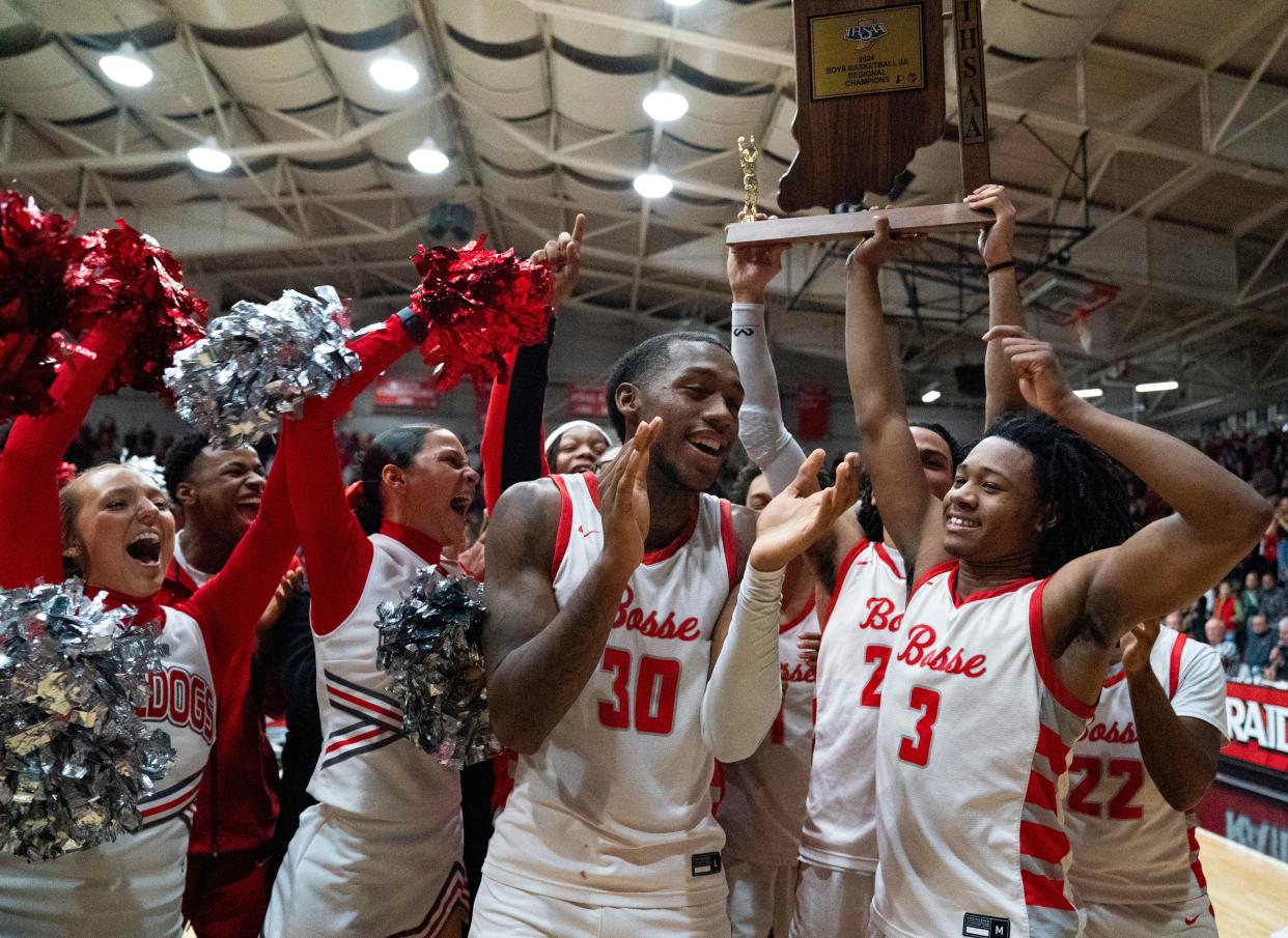The Bosse Bulldogs celebrate after beating the Southridge Raiders to win the 2024 IHSAA Class 3A Boys Basketball Regional at Memorial Gym in Huntingburg, Ind., Saturday, March 9, 2024.