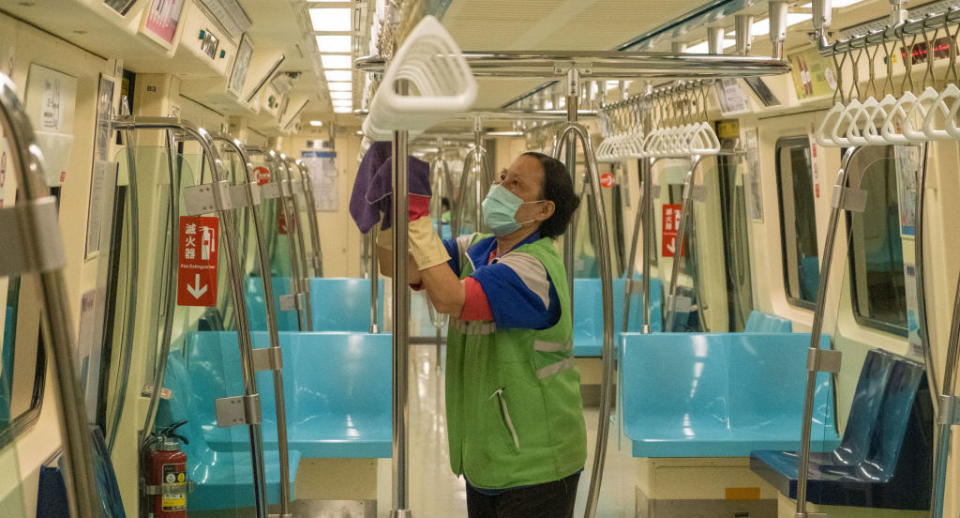 A Metro staff in Taiwan wearing a protective mask and gloves cleans and disinfects a tram as a measure against coronavirus.