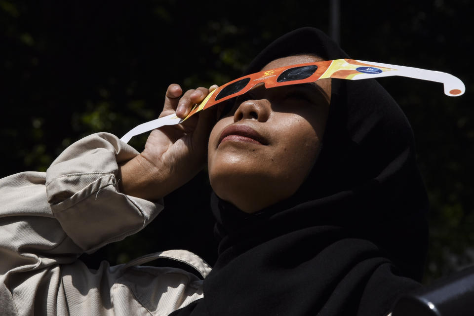 A woman looking up through a pair of special glasses.