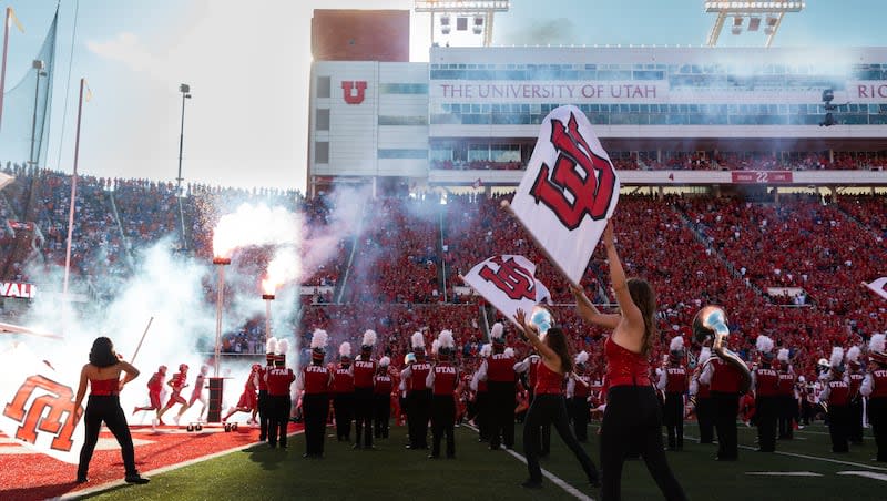 The Utah Utes are greeted as they run onto the field during the season opener at Rice-Eccles Stadium in Salt Lake City on Thursday, Aug. 31, 2023.