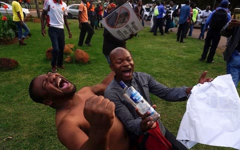 People celebrate in the streets of Harare - Credit: Zinyange Auntony/AFP