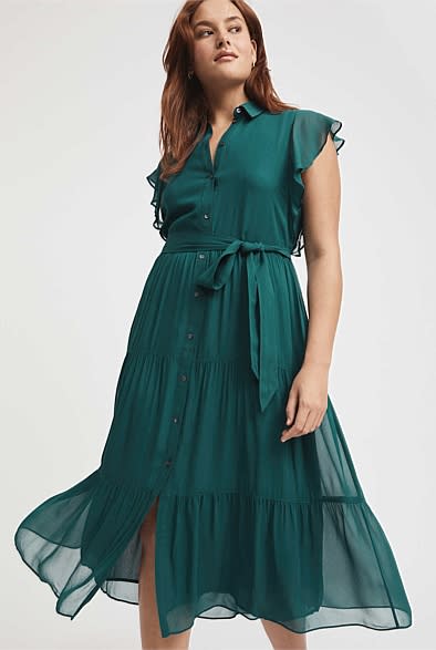 A modeal wears a floaty and ruffled dark green Viscose Georgette Midi Dress, $169.95, from Witchery
